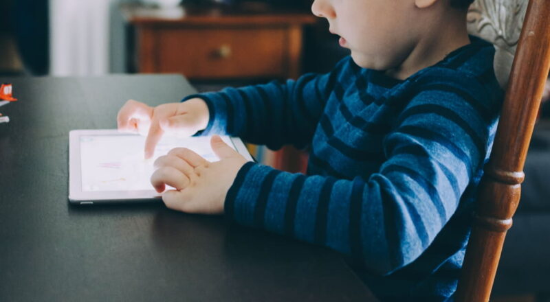 Kind nutzt Tablet – Symbolbild für Bildschirmzeit im Alltag