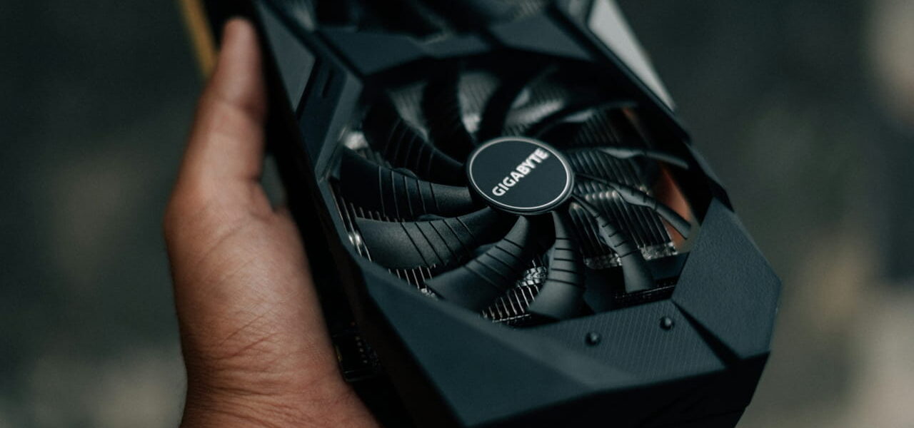 Moderne Gigabyte Grafikkarte mit zwei Lüftern in der Hand gehalten